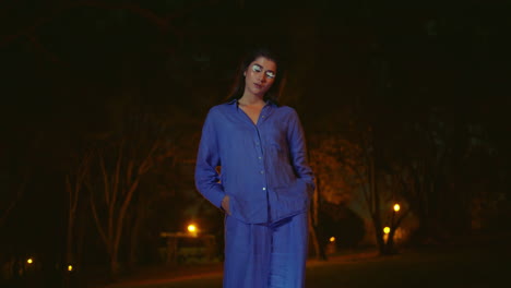 woman looking environmental cleanup result standing over waste bags glowing.