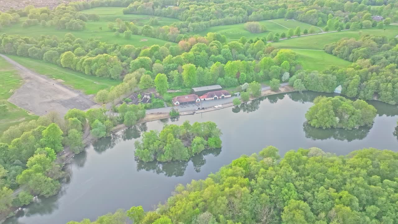 Aerial: Heaton Park with lake during the day in Prestwich, Manchester, England, crane up drone shot