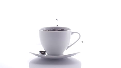 coffee beans falling into cup