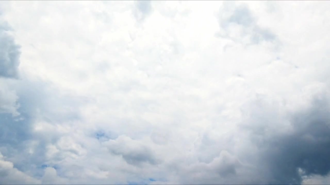 Timelapse of clouds drifting across a clear blue sky, capturing natural atmospheric motion and changing weather in a peaceful outdoor landscape.
