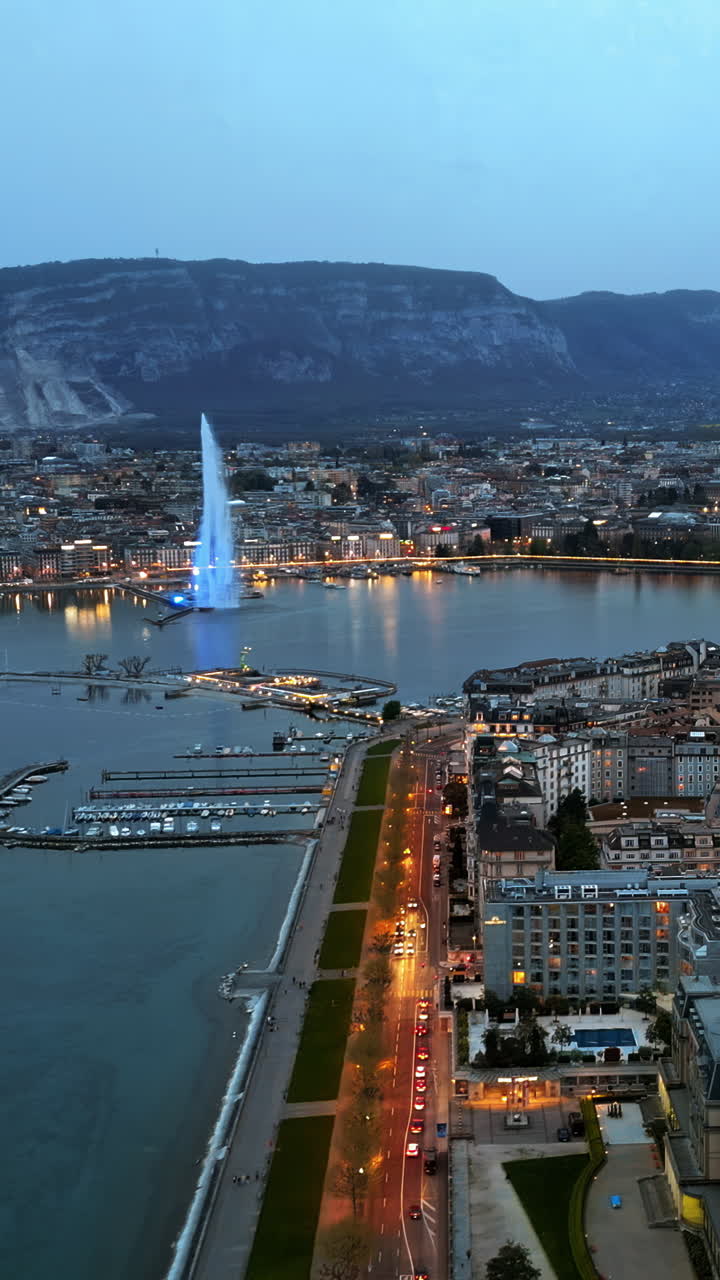 Aerial, drone view of the Geneva Water Fountain in Switzerland in the evening. Vertical