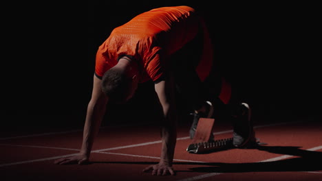 sprinter preparing at starting blocks