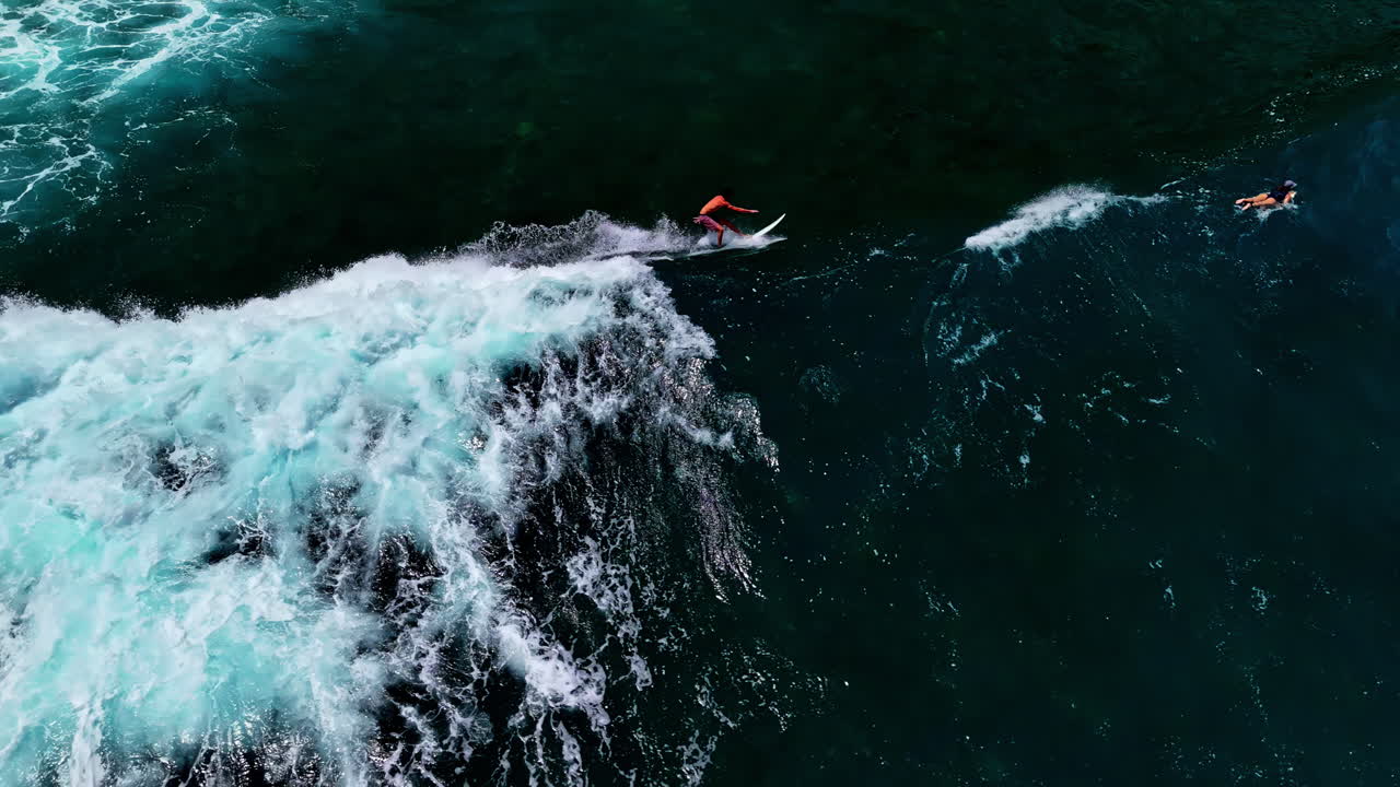 Aerial view of person surfing though beautiful tides at Nyang Nyang beach. It display the thrill and adventure of this water sports as the wave grows gradually