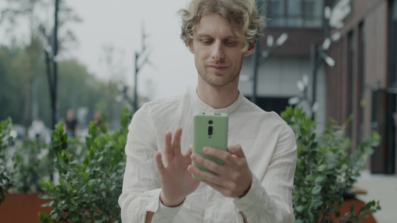 Man looking at his mobile phone outside
