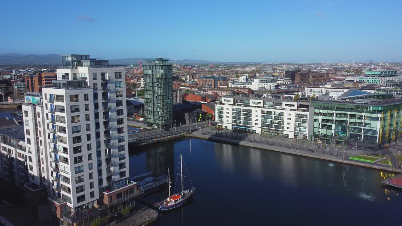 vista aérea del círculo alrededor del edificio de la torre del milenio, con el gran canal, oficinas, apartamentos y panorama de dublín en el fondo