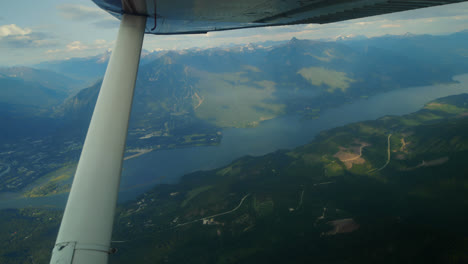 aircraft wing against the mountain and river 4k