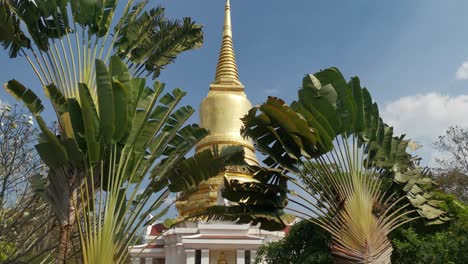 beautiful wat wang phu sai kuti thai temple with golden stupa against blue skies in phetchaburi, thailand