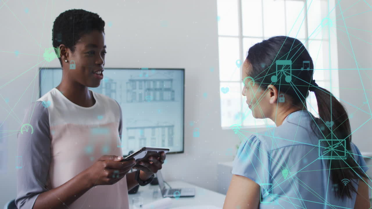 Animation of media icons over diverse business people talking in office