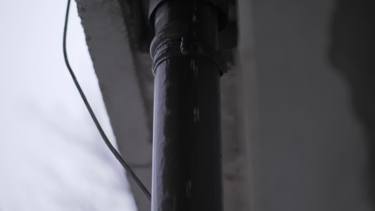 agua de lluvia en la alcantarilla del techo dañada