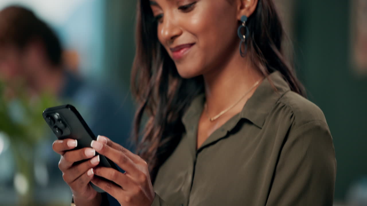 Woman using smartphone at desk
