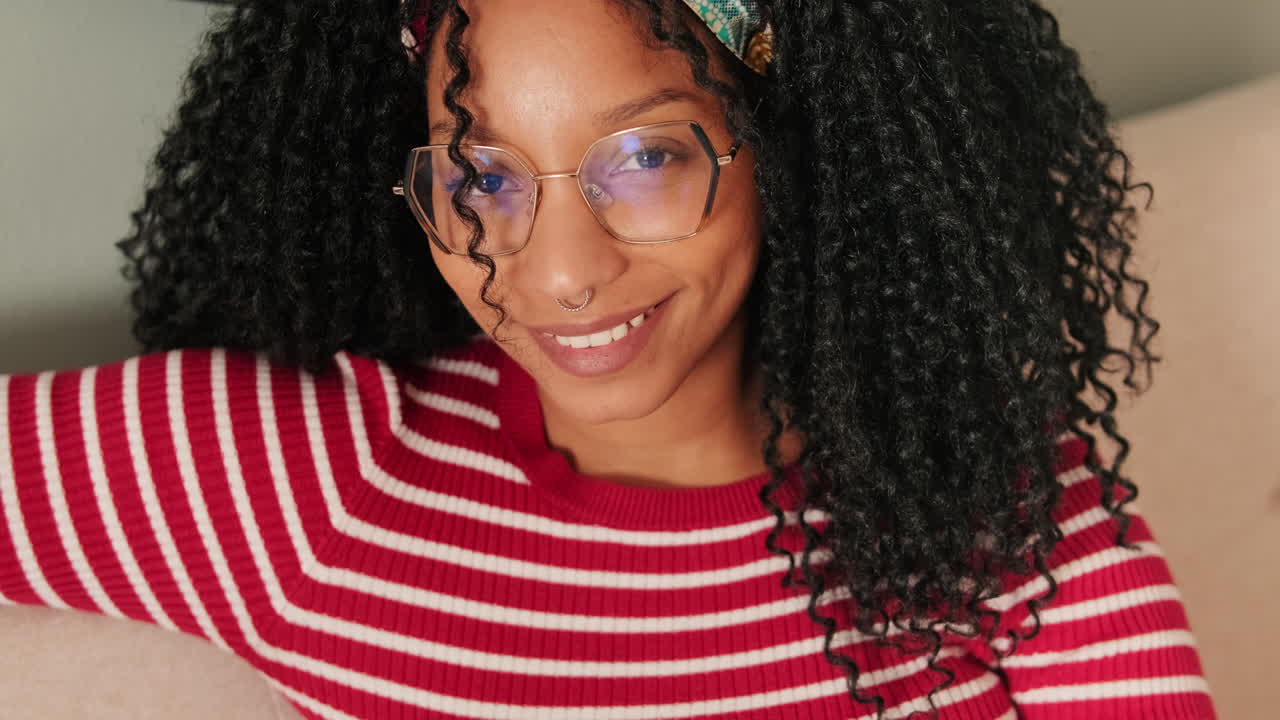 Smiling Young African American Woman with Curly Hair and Glasses