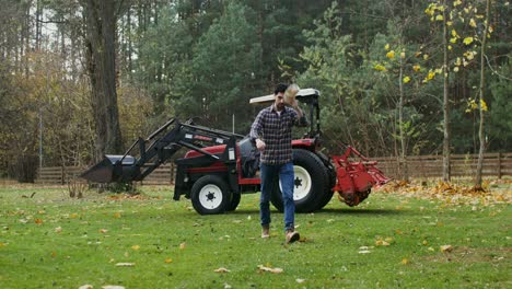 farmer working in the autumn field with tractor