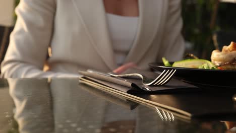 woman setting table at restaurant