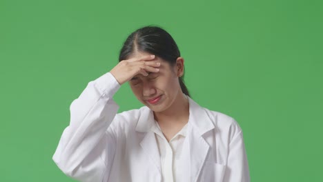 woman with headache in lab coat