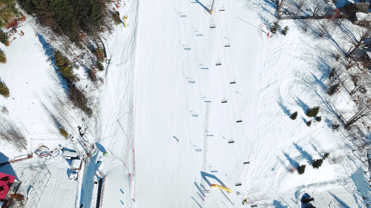 Veduta aerea dall'alto di una seggiovia in una soleggiata giornata invernale