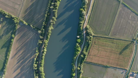 river and agricultural crop fields sunset time aerial top view france camargue