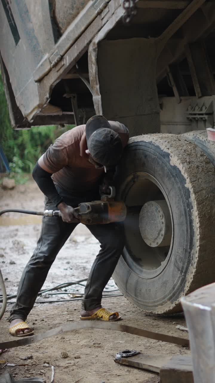 Mechanic repairing a truck tire