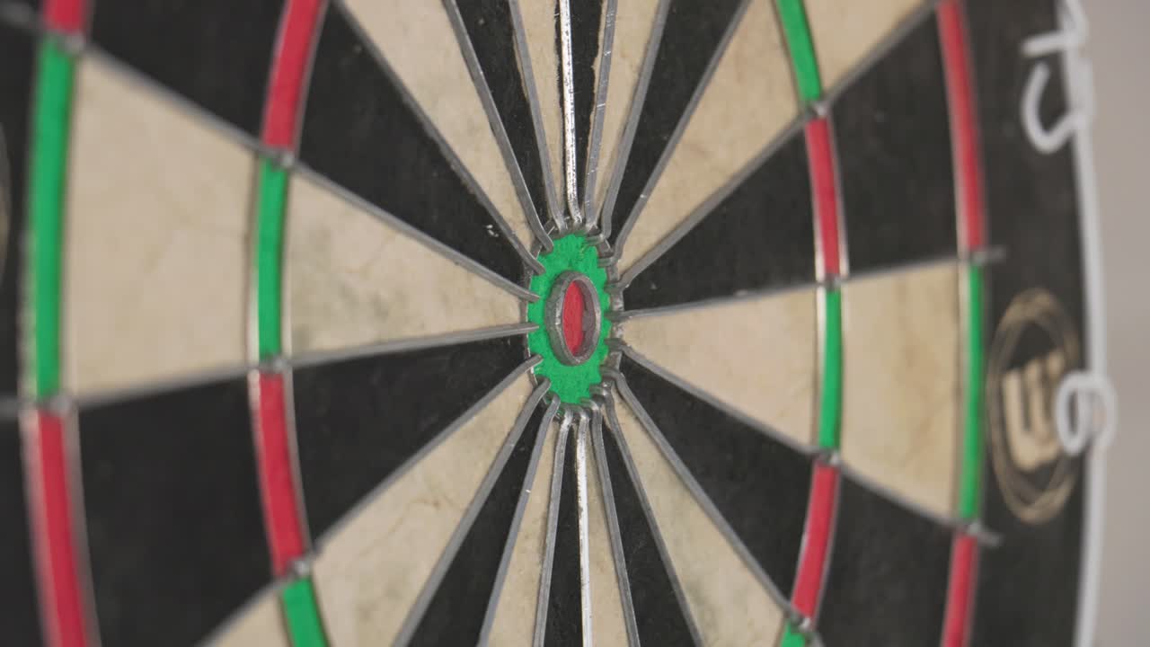 Close-Up Dart Hits Bullseye From Sharp Angled Dartboard View