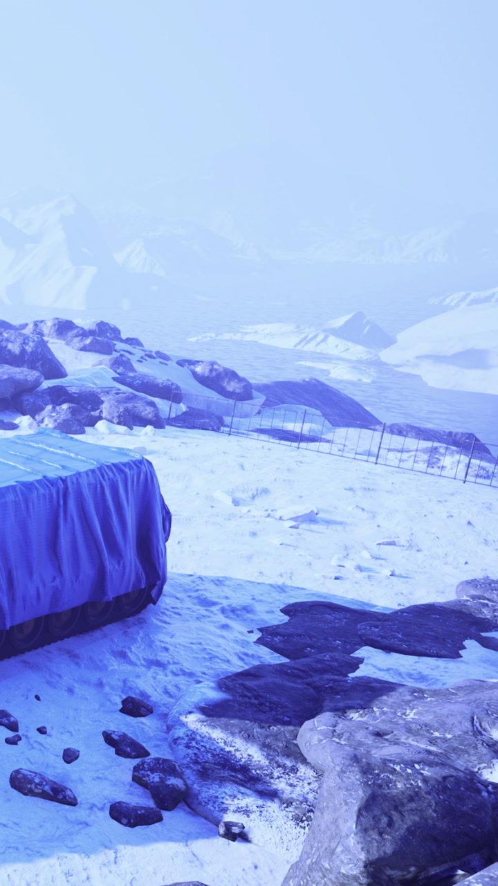 Snowy landscape with rocks and fabric under clear sky in winter