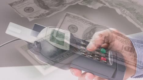 Animation-of-dollar-banknotes-falling-over-hand-of-caucasian-man-holding-payment-terminal