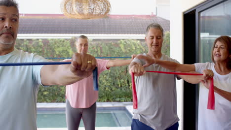 exercising with resistance bands, senior friends enjoying group workout session