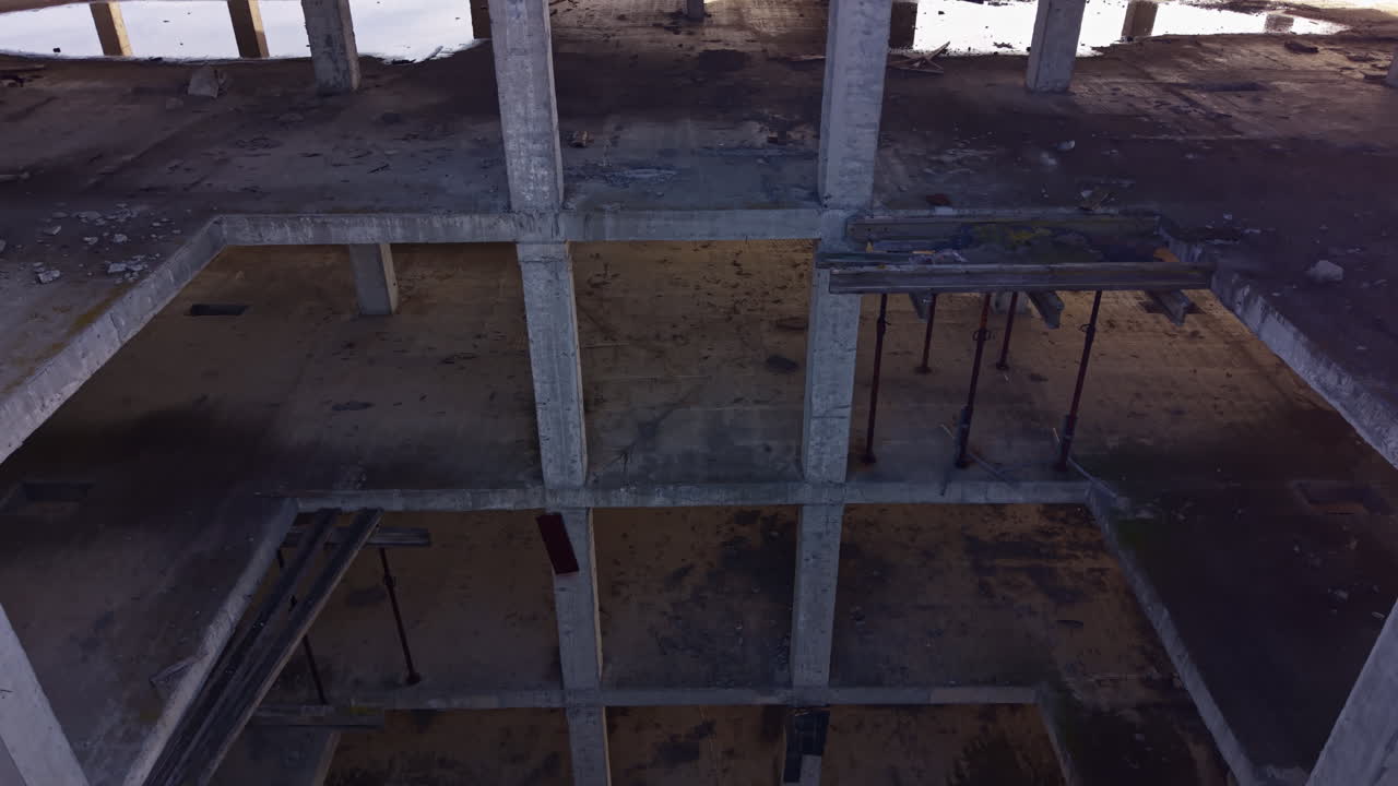 Exploring the vast emptiness of an abandoned concrete structure in the heart of the city during golden hour
