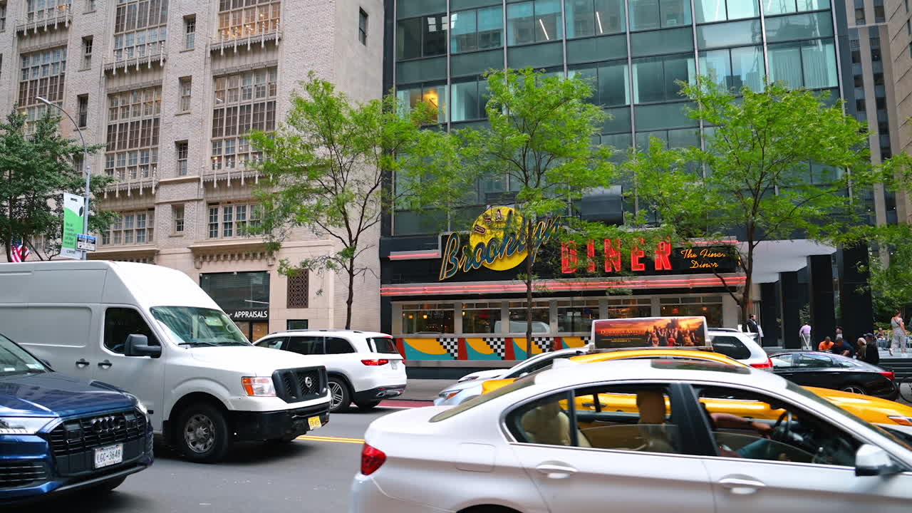 Brooklyn Diner sign with traffic on Manhattan street