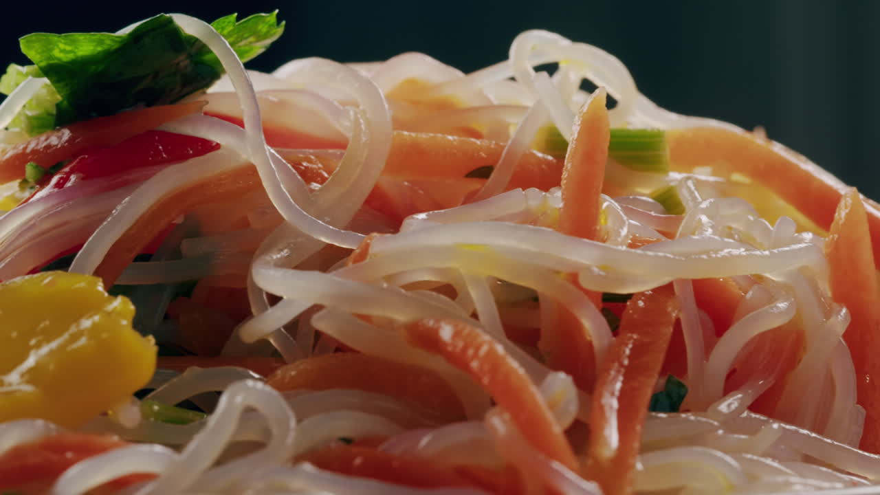 Glass noodles salad with meat and carrots fermented close up asian chinese traditional food.