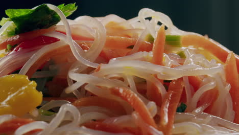 glass noodles salad with meat and carrots fermented close up asian chinese traditional food.