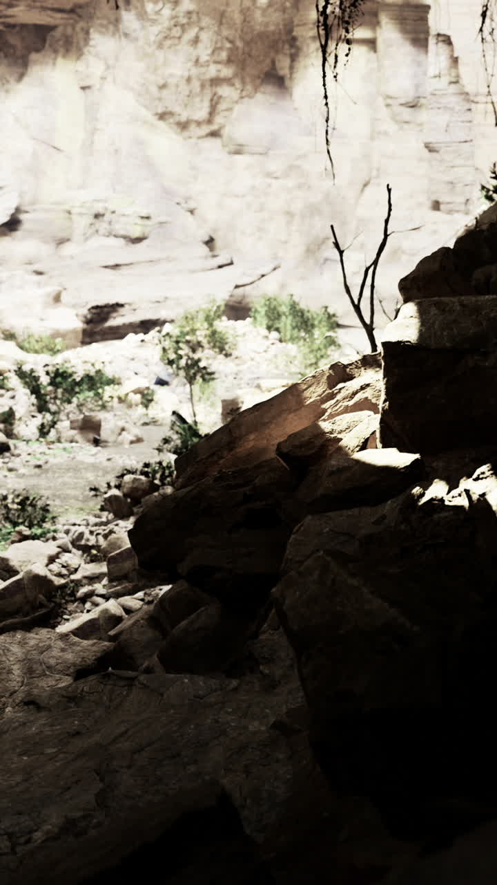 Light breaks through rocky canyon creating mysterious shadows and textures