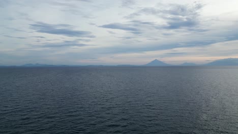 stunning aerial view captures the sun setting behind the islands as we fly over the ocean, revealing the mesmerizing beauty of nature and mayon volcano silhouette