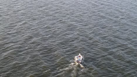 motor boat sailing on wavy ocean during windy summer day