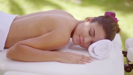 relaxed young woman at an outdoor spa