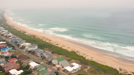 misty drone view of travel beach town and ocean waves