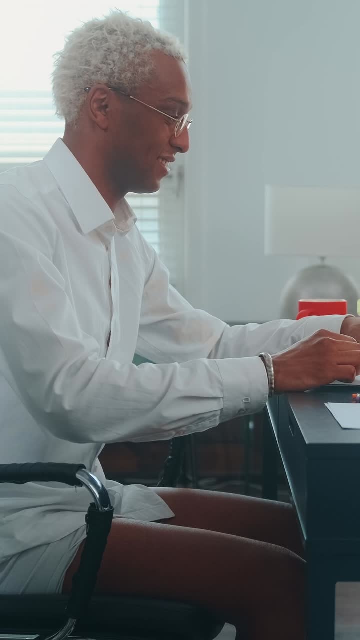 Man greeting someone while working from home in bright office space