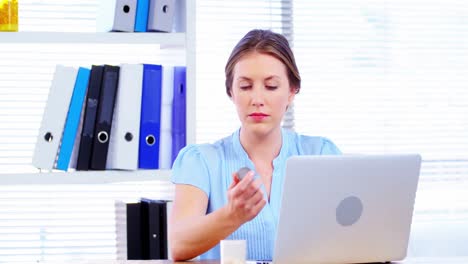 Female-doctor-working-over-laptop-at-her-desk