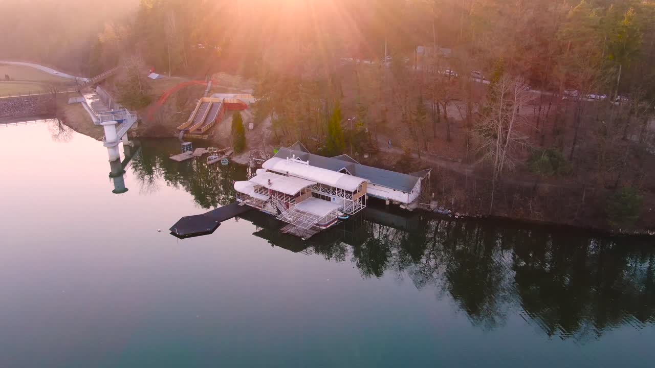 aerial view lakeside building with pier. Calm water. Smartinsko lake, Celje