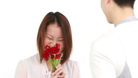 man offering flowers to his girlfriend