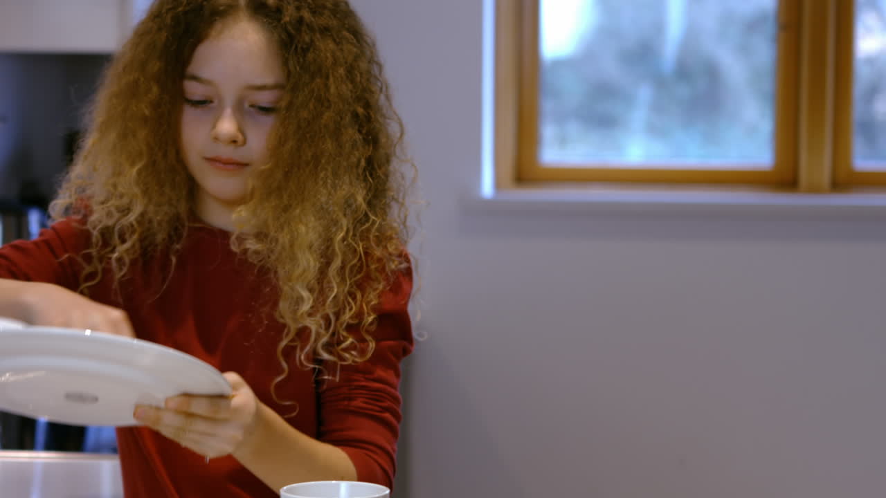 Portrait of mother and daughter are doing the dishes together 