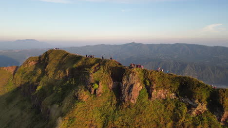 hikers move along mount batur ridge line at sunrise bali indonesia