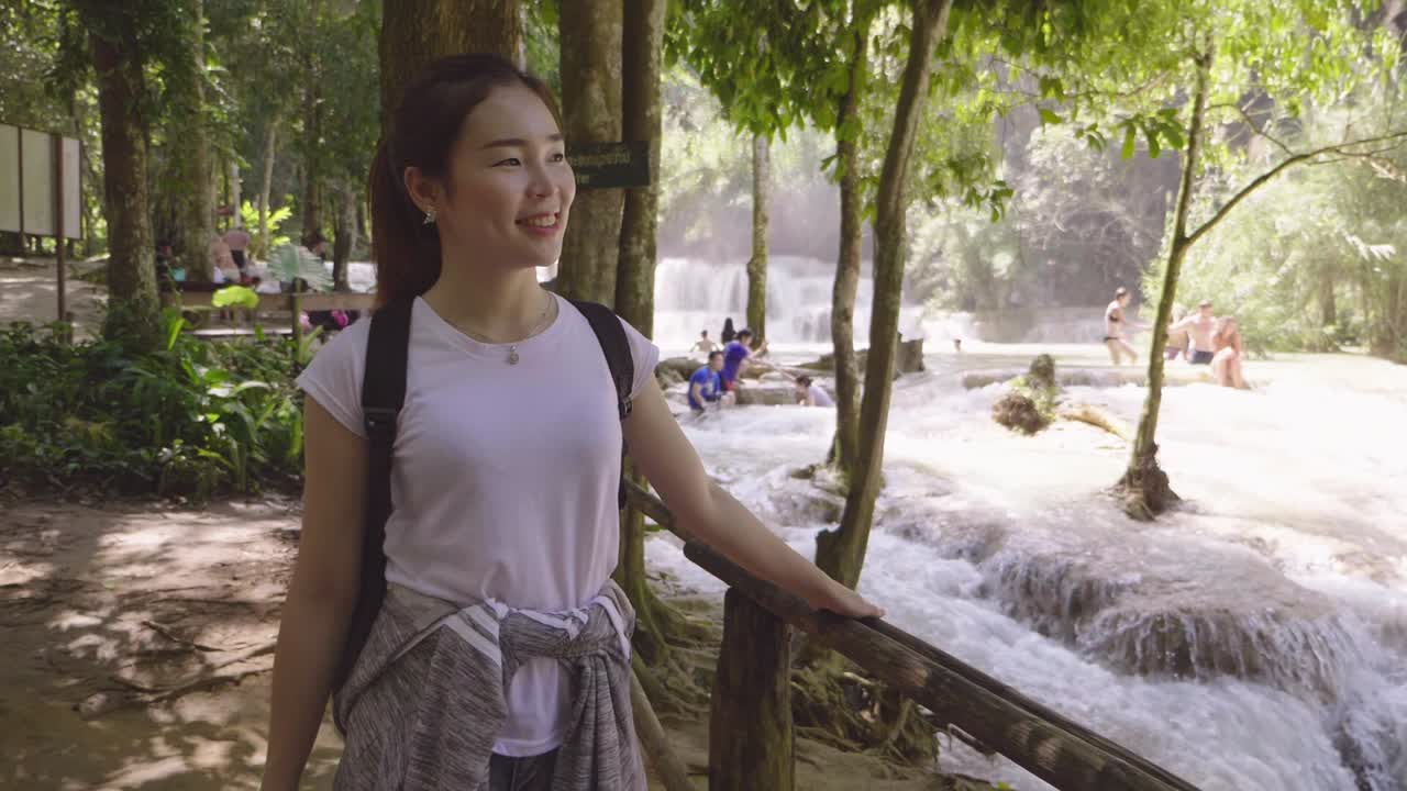 Woman enjoying the waterfall scenery