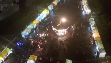 drone view of christmas stalls and carousel on the podgorski square with st