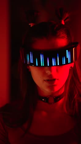 woman with led glasses in a dark setting