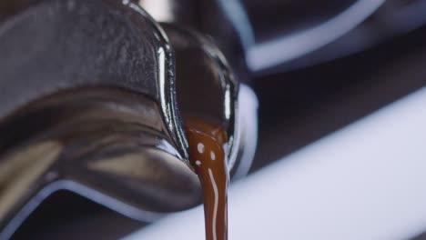 close up of coffee maker pouring freshly brewed quality coffee in the morning