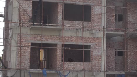 a brick building under construction with scaffolding.