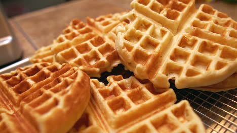 freshly made waffles cooling and ready for a big family breakfast feast - push forward close up