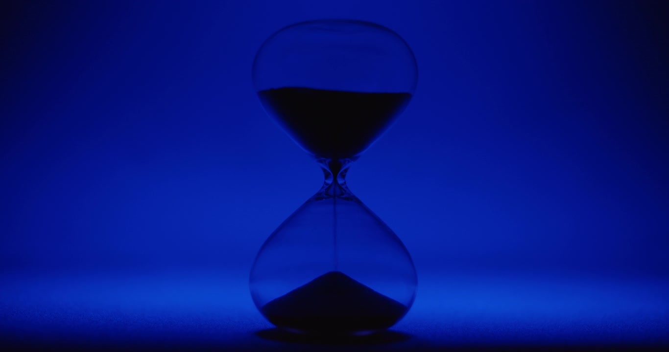 Sand clock on blue background