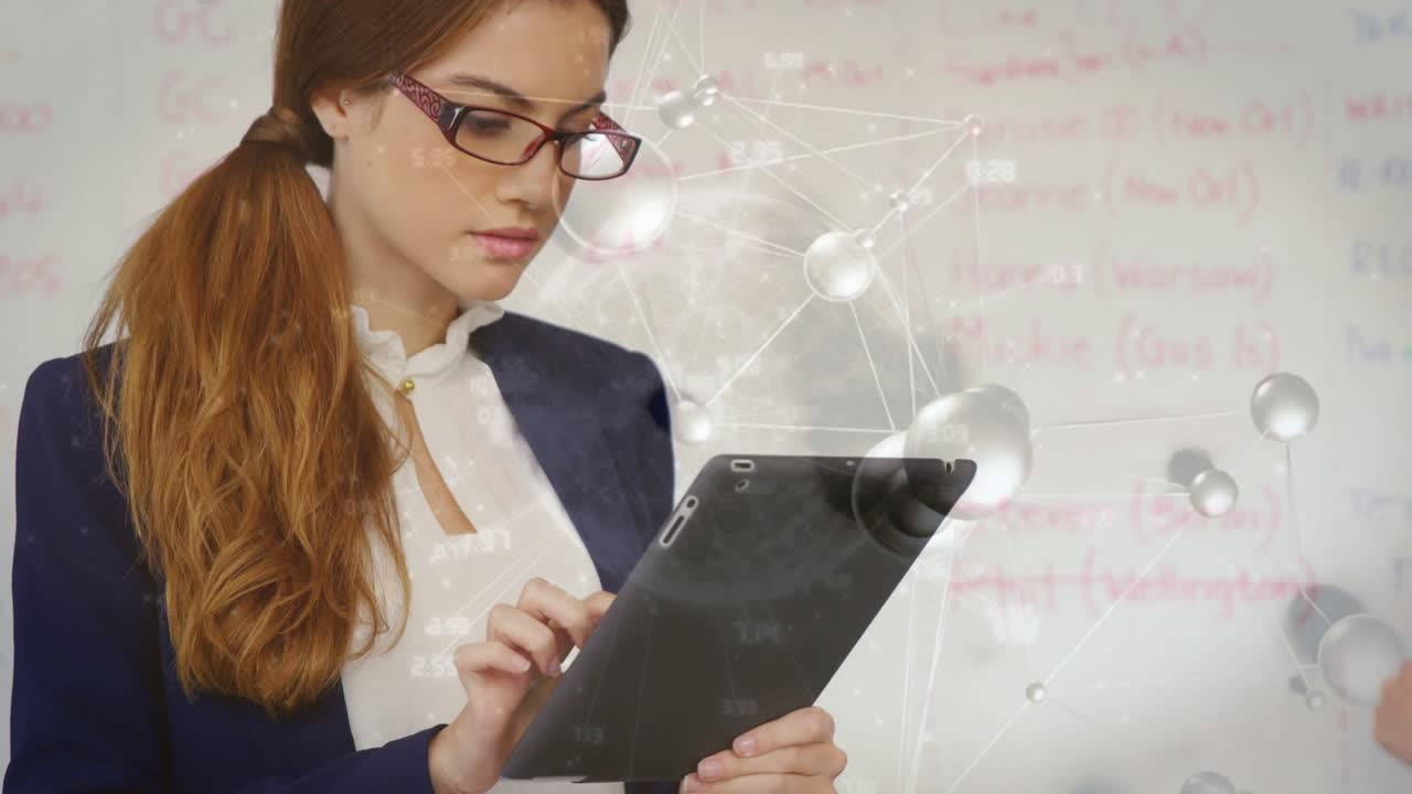 Woman tapping tablet and causing science overlay while working with peer writing on whiteboard