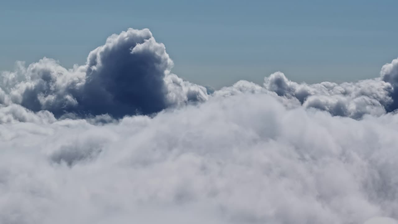 Aerial: sea of fog above the clouds in high altitude during the day, outdoor, orbit drone shot
