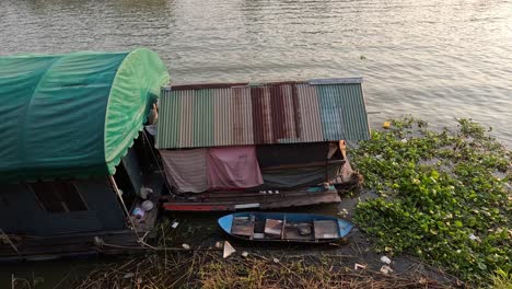 scenes of stilt houses and boats by the river